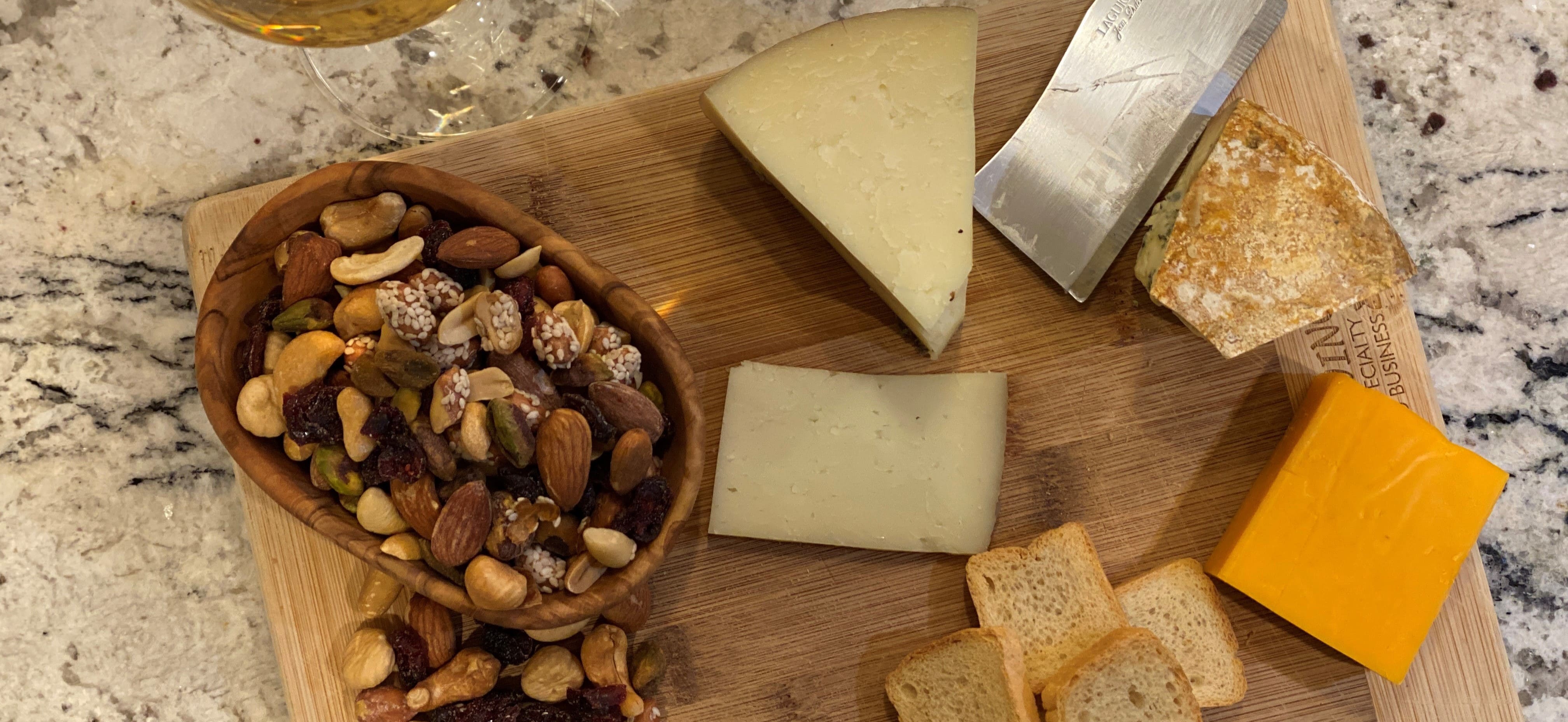 Nuts and cheese on a cutting board